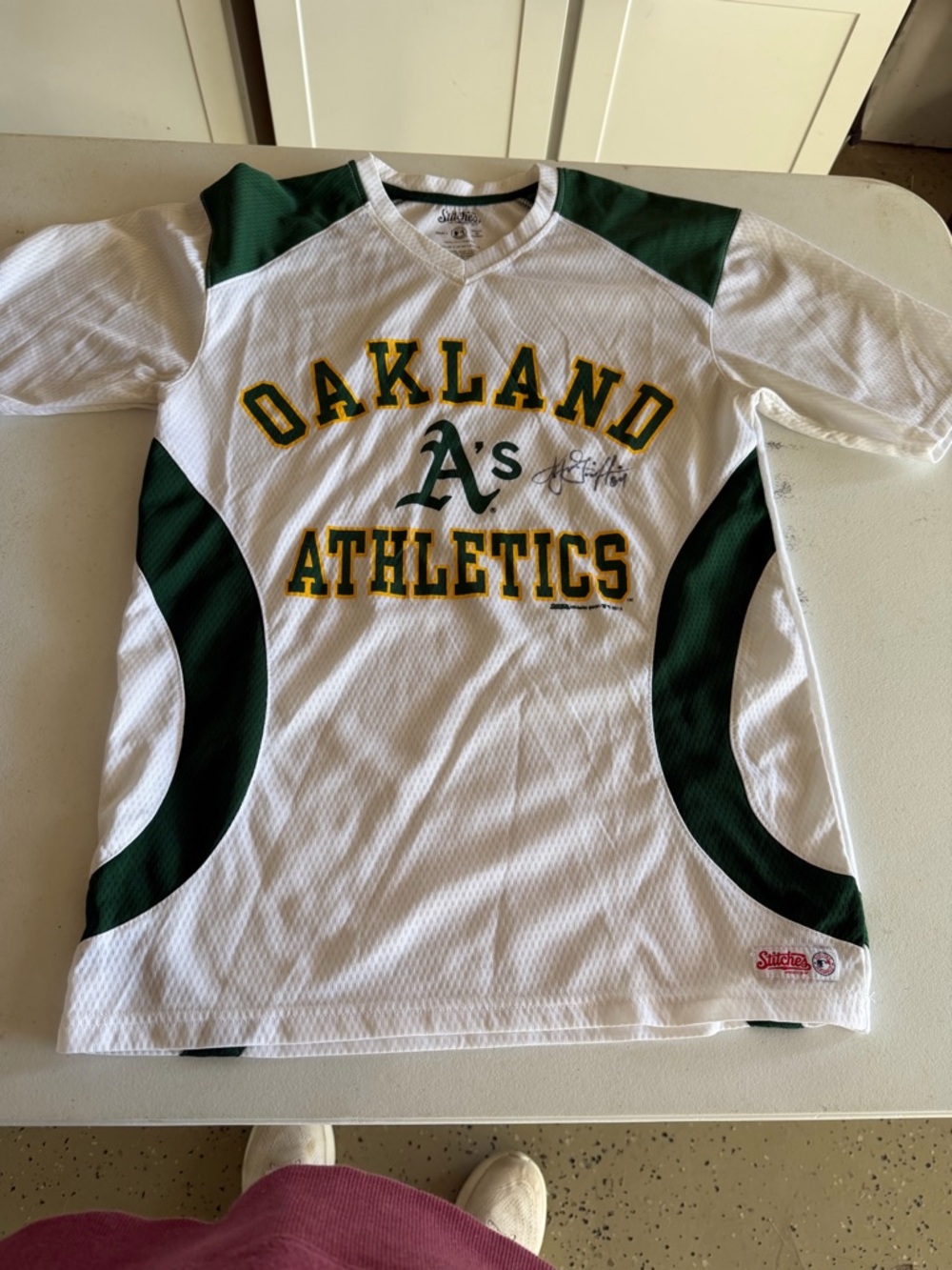 Stitches White Jersey Top with Green Trim autographed.
Athletic’s A’s
